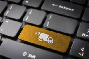 Transport delivery key with truck icon on laptop keyboard.
